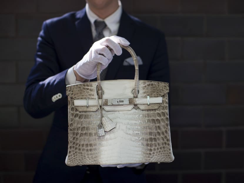 An employee holds a Hermes diamond and Himalayan Nilo Crocodile Birkin handbag at Heritage Auctions offices in Beverly Hills, California, United States in this Sept 22, 2014 file photo. Photo: Reuters