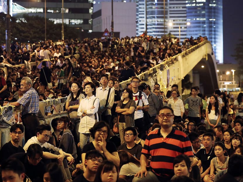 Pro-democracy protesters attend a rally in the occupied areas outside government headquarters in Hong Kong’s Admiralty, Friday, Oct. 10, 2014. Thousands of people are pouring into a main road in Hong Kong to show support for a pro-democracy protest after the government called off talks with student leaders. (AP Photo/Kin Cheung)