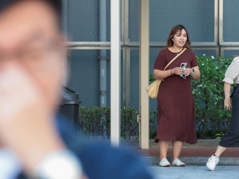 Jamie Lee Xiuling (in brown) leaving the State Courts on May 14, 2024. 