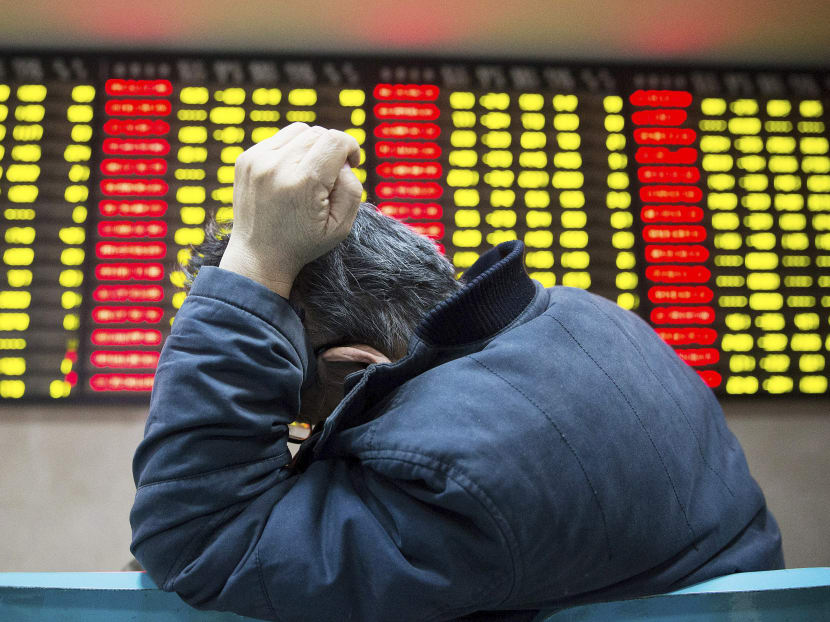 An investor sits in front of an electronic board showing stock information at a brokerage house in Nanjing, Jiangsu province, China, December 8, 2015. Photo: Reuters