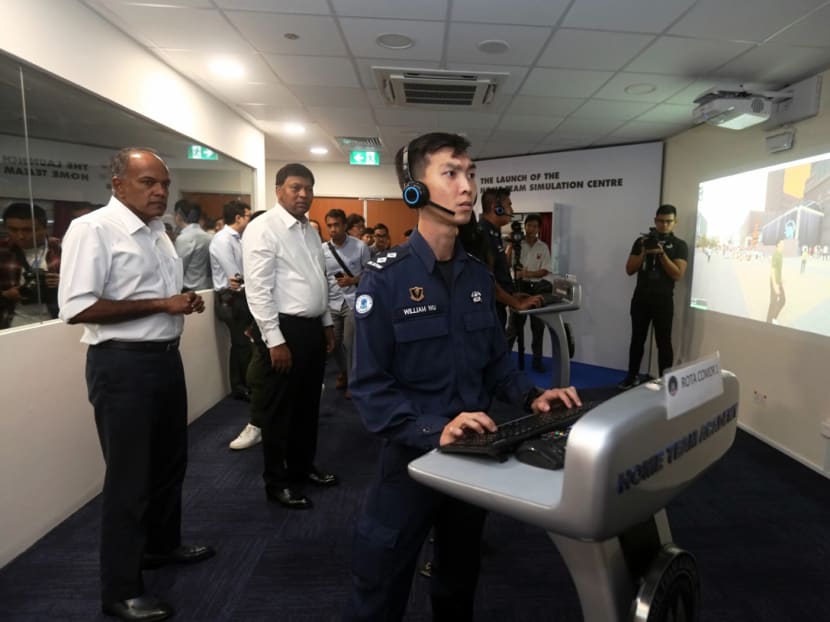 Minister for Home Affairs and Law K Shanmugam (far left), observes a training for on-site officers at the Home Team Simulation Centre.