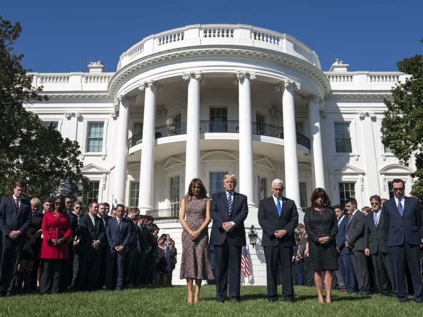 President Donald Trump and first lady Melania Trump stand with Vice President Mike Pence and his wife, Karen Pence, during a moment of silence for the victims of the mass shooting in Las Vegas on the South Grounds of the White House in Washington. Photo: The New York Times