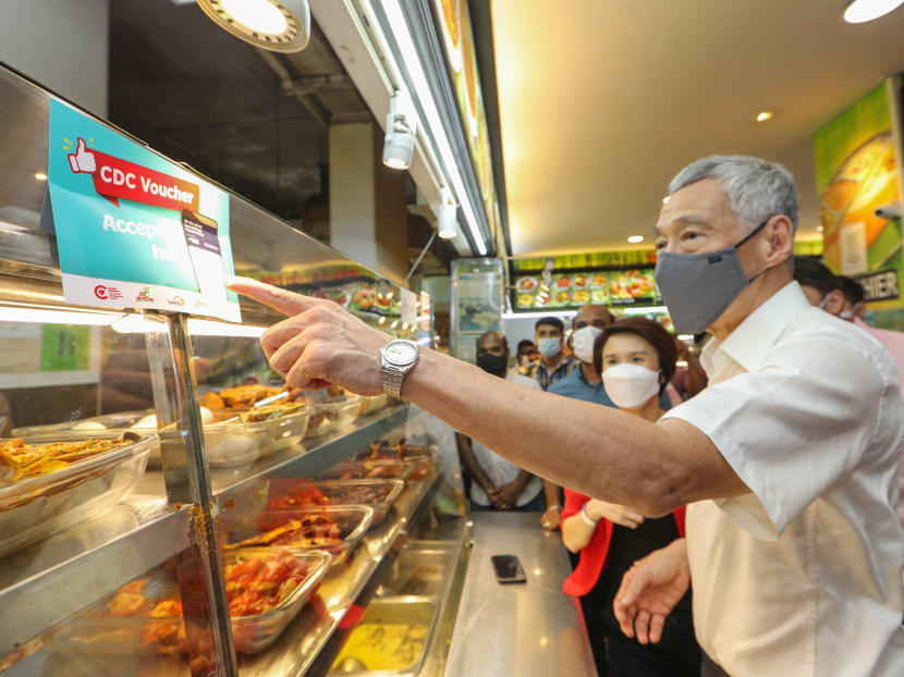 Prime Minister Lee Hsien Loong (pictured) said that the Community Development Council vouchers are meant to support shops and hawker stalls in neighbourhoods that have been hit hard by the Covid-19 pandemic.