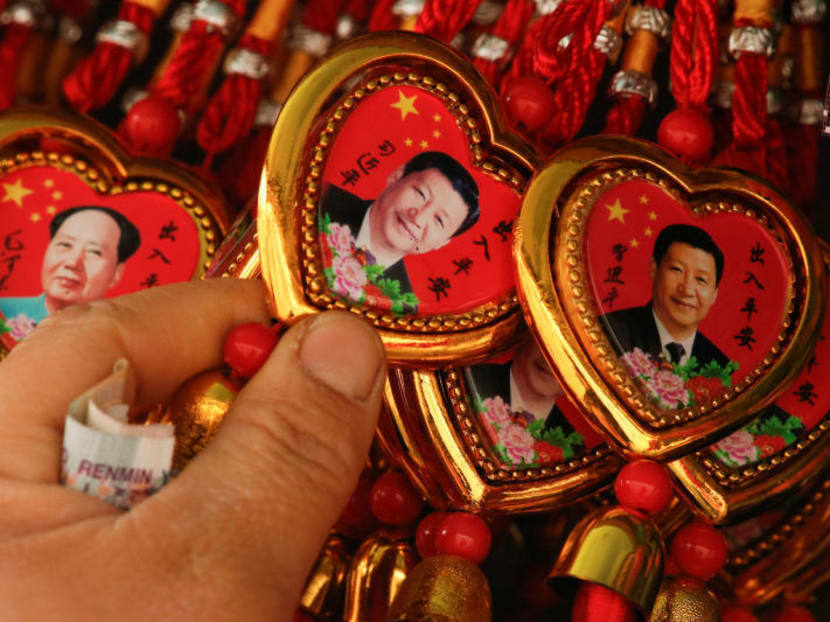 A souvenir necklace with a portrait of Chinese President Xi Jinping at a stall in Beijing. REUTERS