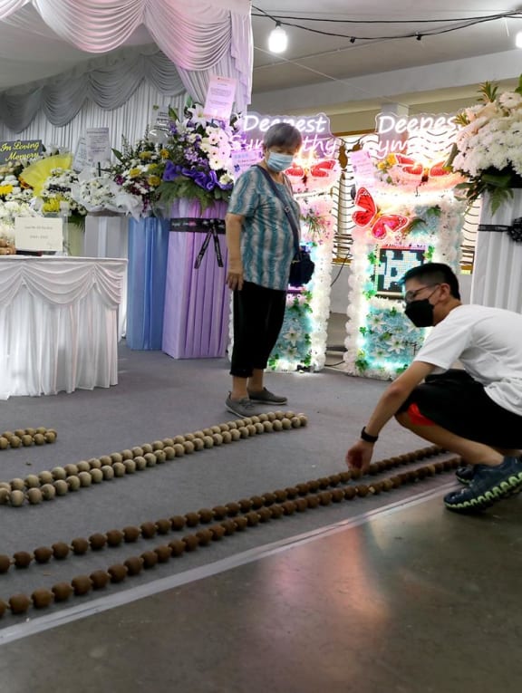 Madam Hew Lin Yin, 77, and Oh Wei Heng, 17, who are the wife and grandson of the late Oh Ow Kee, at his funeral wake on June 8, 2022. 