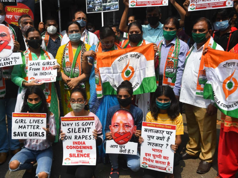 Political activists hold placards and cut-outs of India's prime minister Narendra Modi and chief minister of Uttar Pradesh Yogi Adityanath during a protest to condemn the alleged gang-rape and murder of a teenaged woman in Bool Garhi village at Hathras in Uttar Pradesh state.