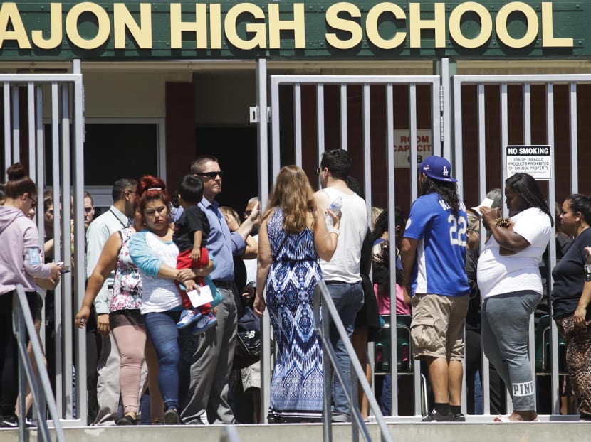 Parents and guardians of North Park Elementary School students wait at Cajon High School to pick up their children on April 10, 2017, in San Bernardino, Calif. Photo: AP