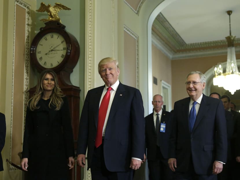 US President-elect Donald Trump talks to the media with his wife Melania Trump after a meeting with Senate Majority Leader Mitch McConnell (right) on Capitol Hill in Washington, DC on Nov 10, 2016. Photo: AFP
