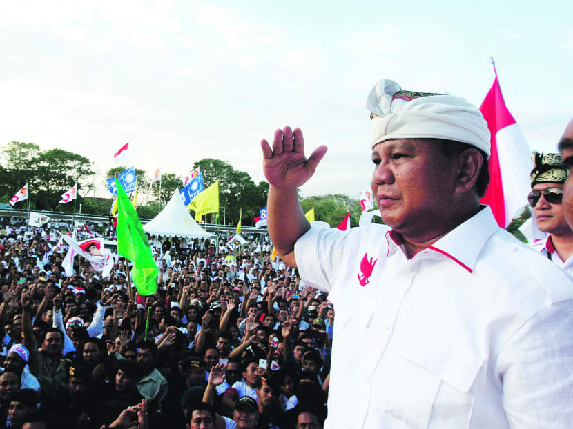 Indonesian presidential candidate Prabowo Subianto (right) greets his supporters during his election campaign rally in Bali, Indonesia, on Sunday. Indonesia will hold its presidential poll on July 9. Photo: AP