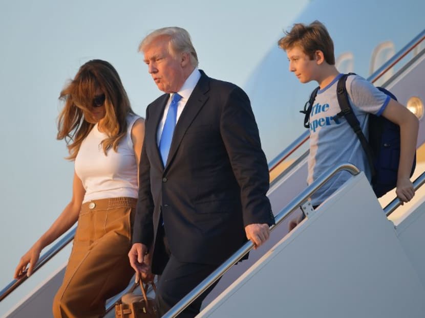 United States President Donald Trump (centre), First Lady Melania Trump, and their son Barron Trump walking off Air Force One after arriving at Andrews Air Force Base, Maryland on June 11, 2017. Photo: AFP