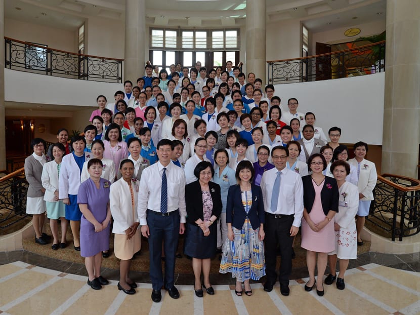 Recipients of the Nurses' Merit Award posing for a group photo with Dr Amy Khor (Senior Minister of State, Ministry of the Environment and Water Resources & Ministry of Health). Photo: Robin Choo/TODAY