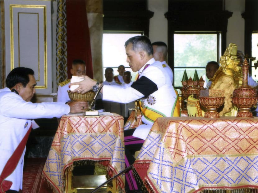 In this photo release by Bureau of the Royal Household, Thailand's King Vajiralongkorn Bodindradebayavarangkun left, endorsed the document in an elaborate ceremony back to Thailand's Prime Minister Prayuth Chan-ocha  at the Ananta Samakhom Throne Hall  in Bangkok, Thailand, Thursday, April 6, 2017. Photo: Bureau of the Royal Household via AP