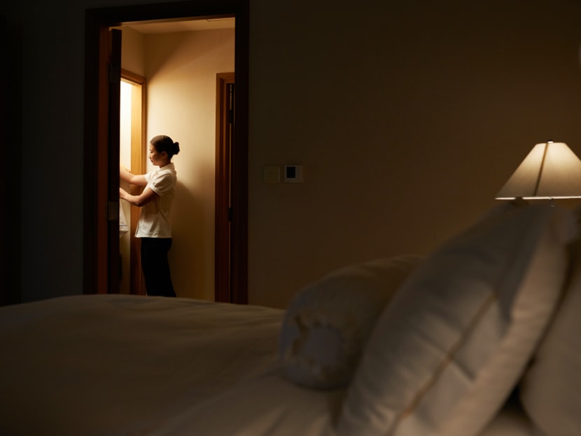 A housekeeping staff member is seen in a hotel room. Industry players admit that they struggle to upkeep the quality of service as there simply aren't enough warm bodies. 