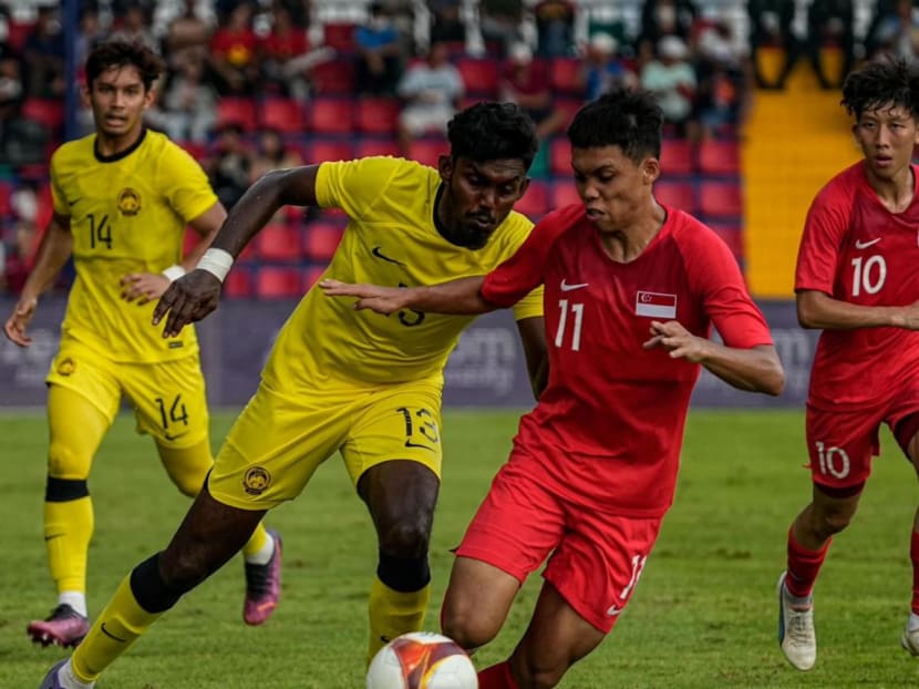Singapore and Malaysia players in their SEA Games football match on May 11, 2023