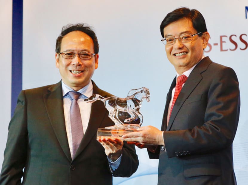 Professor Euston Quah (left) presenting Finance Minister Heng Swee Keat with an honorary fellowship of the Economic Society of Singapore. In a speech, Mr Heng stressed that human and corporate capabilities go hand in hand. Photo: Najeer Yusof