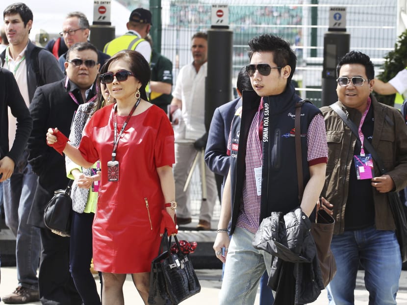 In this June 30, 2013, photo provided by XPB Images, Vorayuth "Boss" Yoovidhya, second right, whose grandfather co-founded energy drink company Red Bull, walks with his mother Daranee, second left, during the British Formula 1 Grand Prix at Silverstone circuit, Silverstone, England. Vorayuth is accused of killing a Thai police officer in a hit-and-run in 2012, yet he still has not appeared to face charges. Photo: XPB Images via AP