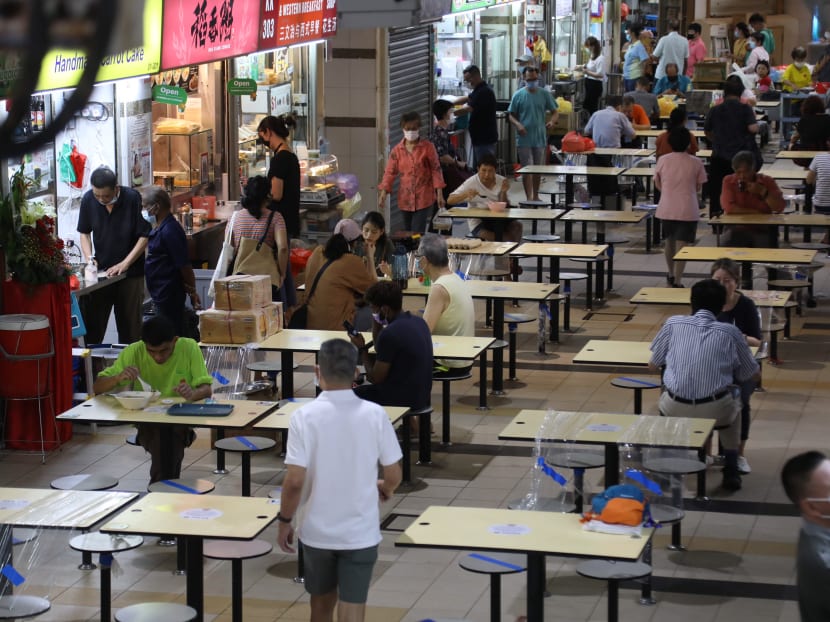 People having their meals at the hawker centre of Tekka Centre during lunchtime on July 19, 2021. Tekka Centre is among 10 market and food centres where fishmongers working there have been infected by the coronavirus.