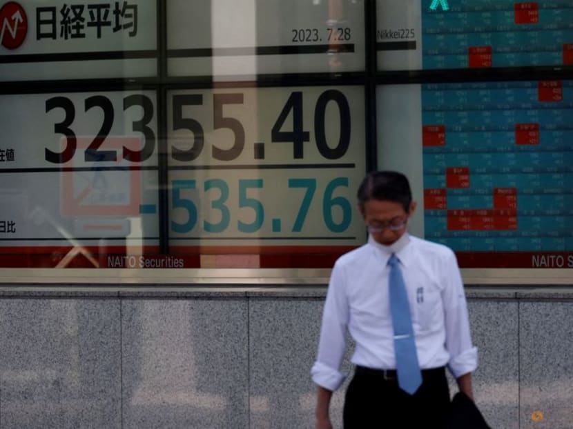 FILE PHOTO: A man stands in front of an electric board displaying the Nikkei stock average outside a brokerage in Tokyo, Japan, July 28, 2023. REUTERS/Kim Kyung-Hoon/File Photo/File Photo FILE PHOTO: A man stands in front of an electric board displaying the Nikkei stock average outside a brokerage in Tokyo, Japan, July 28, 2023. REUTERS/Kim Kyung-Hoon/File Photo/File Photo