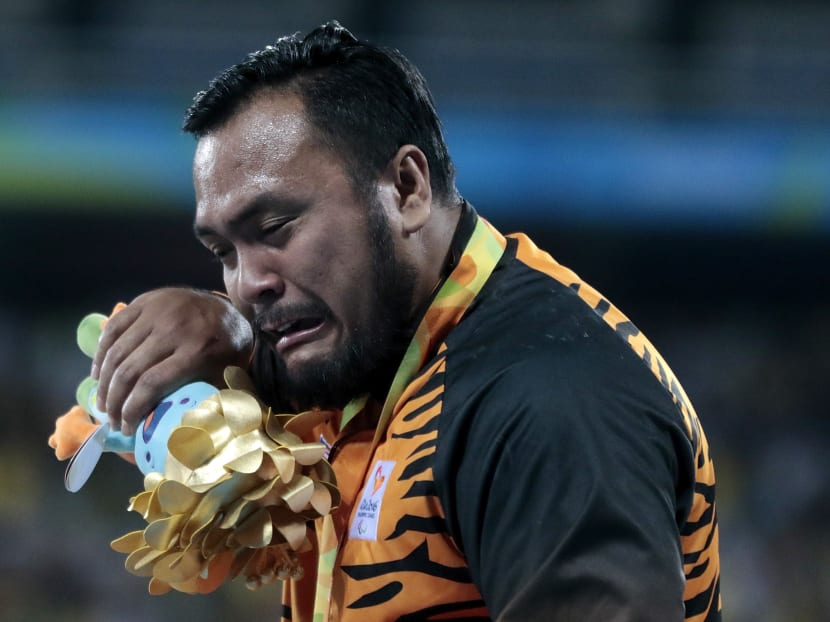 Gold medalist Muhammad Ziyad Zolkefli of Malaysia celebrate on the podium at the medal ceremony for the Men's Shot Put F20 Final during day 3 of the Rio 2016 Paralympic Games at the Olympic Stadium on September 9, 2016 in Rio de Janeiro, Brazil. Photo: Getty Images