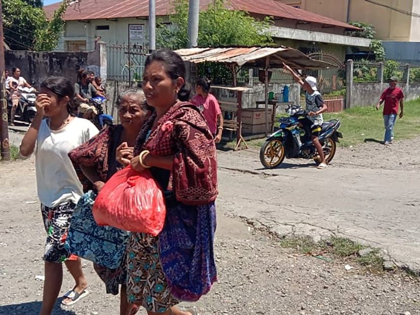 Women are seen evacuating, as a 7.4-magnitude earthquake struck eastern Indonesia triggering a tsunami warning in Maumere, East Nusa Tenggara, Indonesia on Dec 14, 2021. 