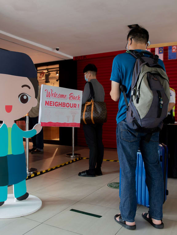 A standee and signage outside Johor Bahru City Square mall with a message welcoming back Singapore visitors to Malaysia on April 1, 2022.