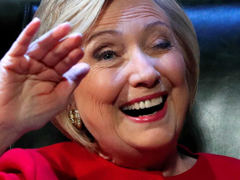 Former US Secretary of State Hillary Clinton smiles and winks at someone she recognises as she takes the stage to discuss her new book What Happened as she launches a 15-city book tour at the Warner Theatre in Washington, US, on Sept 18, 2017. Photo: Reuters