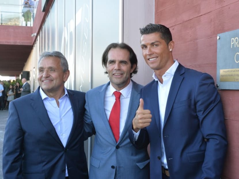 Portuguese forward Cristiano Ronaldo poses with owner and chairman of Pestana Hotel Group, Dionisio Pestana (L) and the regional president of Madeira, Miguel Albuquerque (C) at the opening of the Pestana CR7 Hotel in Funchal, on Madeira island on July 22, 2016. Photo: AFP