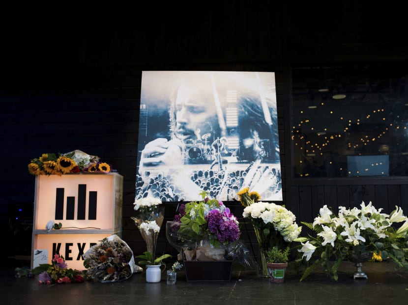 Flowers and cards sit in front of a large image with a depiction of Chris Cornell on it during a memorial for Cornell on May 18, 2017, in Seattle. Photo: seattlepi.com via AP