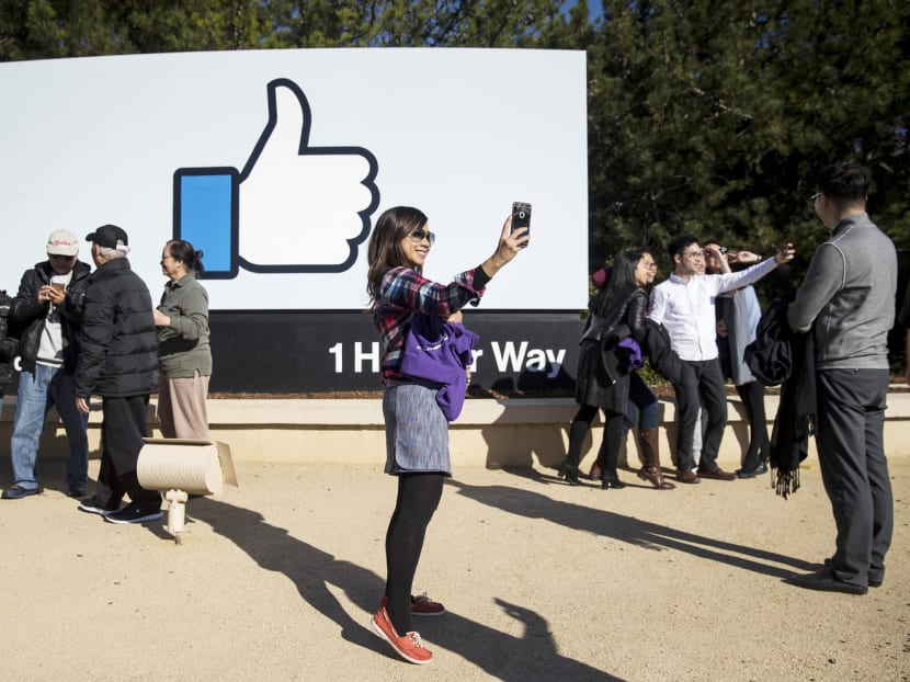 A visitor taking a selfie in front of a Facebook sign at the entrance of the company’s headquarters in Menlo Park, California. Although China’s Internet filters block many of Silicon Valley’s biggest companies, tourists obsessed with the culture still flow steadily to the area. Photo: The New York Times