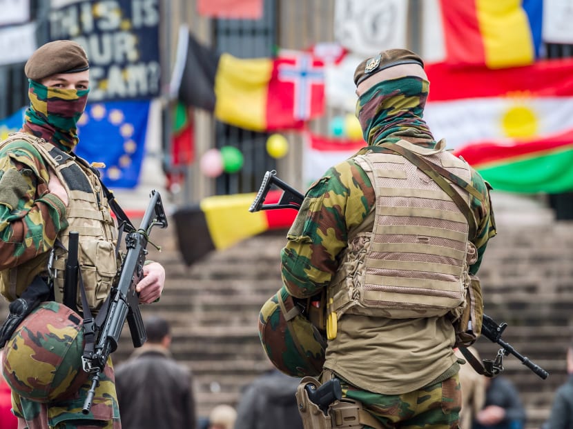 Belgian soldiers guarding a memorial site at the Place de la Bourse in Brussels, which has become a focal point for expressions of sympathy. Photo: AP