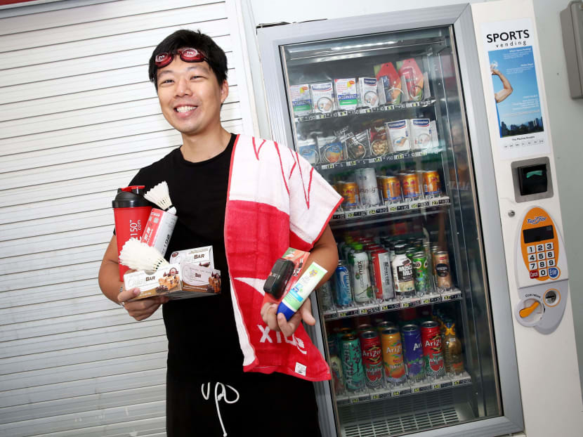 Kegan Tan, 30, owner of Spartan Sports, which caters various sports services including vending machine and online retail businesses. He is adorning some of the products that his sports-themed vending machines will be selling including goggles, towels, and shuttlecocks. Photo: Nuria Ling/TODAY