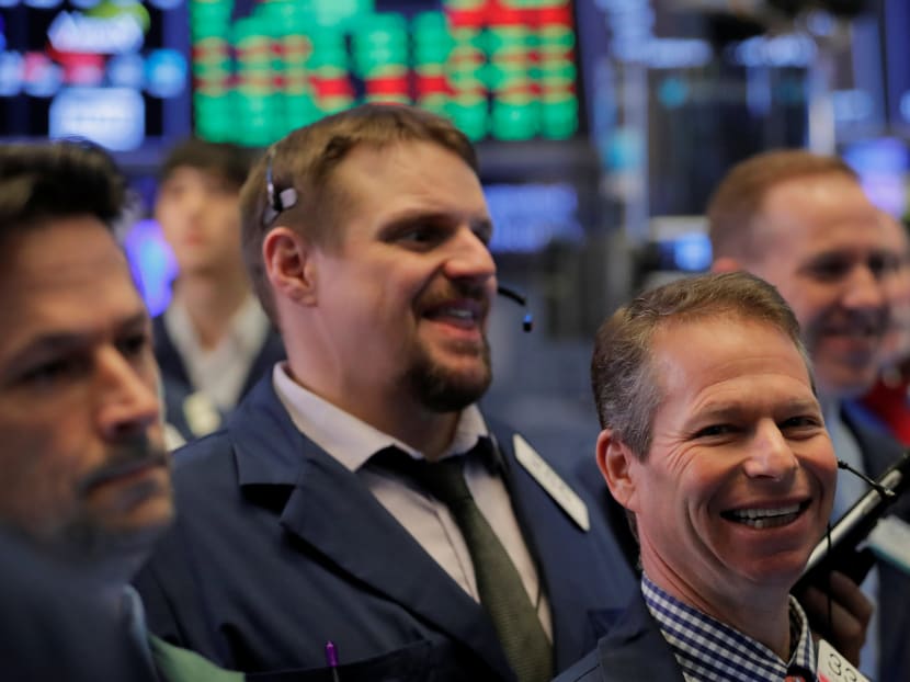 Traders work on the floor of the New York Stock Exchange shortly after the opening bell on Jan 19. The US stock market has risen partly because companies continue to expect that President Donald Trump will adopt pro-business policies. Photo: Reuters