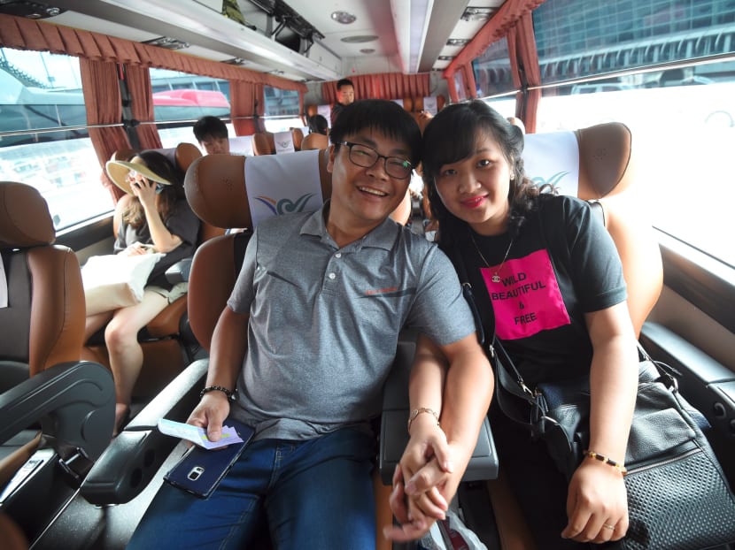 This picture taken on Aug 14, 2017 shows Vietnamese bride Huynh Thi Thai Muoi (R) and her South Korean husband Kim Kyeong-Bok in a bus going to Kim's hometown of Gwangju after their arrival at Incheon airport, west of Seoul.
 Photo: AFP
