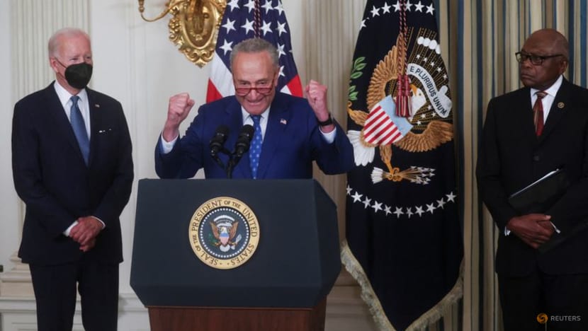 Biden signs inflation act, hands pen to Manchin 