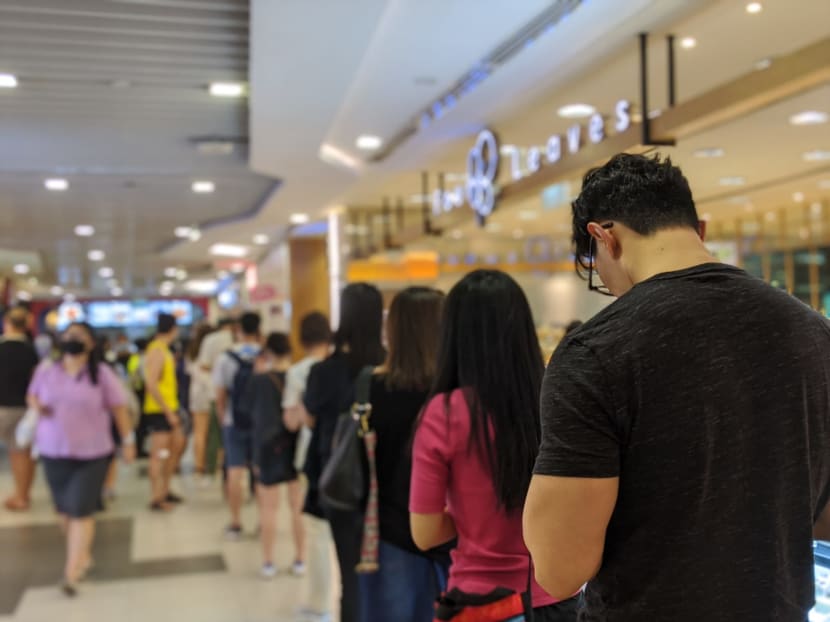 Shoppers lining up to get into Cold Storage supermarket at Bugis Junction on Friday, April 3, 2020. Those heading out to buy daily essentials can now get information on the crowd situation at shopping malls across Singapore through a website called Space Out.
