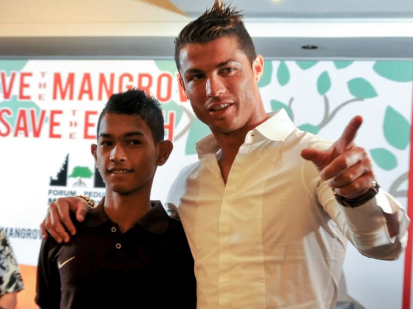 Images of Martunis, whose siblings and mother were killed in the disaster, prompted Cristiano Ronaldo to travel to Aceh to meet him in 2005. The pair have met several times since. Photo: AFP