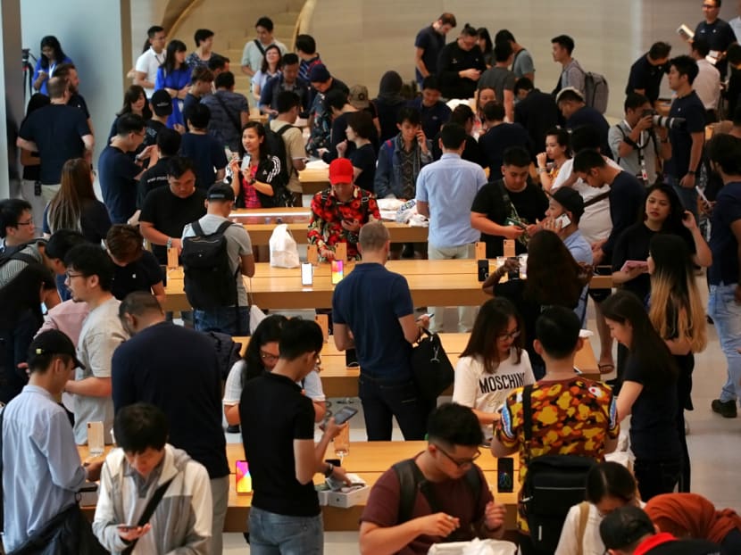 Crowds checking out the new iPhone and other products at the Apple store in Singapore on Friday (Sep 21).