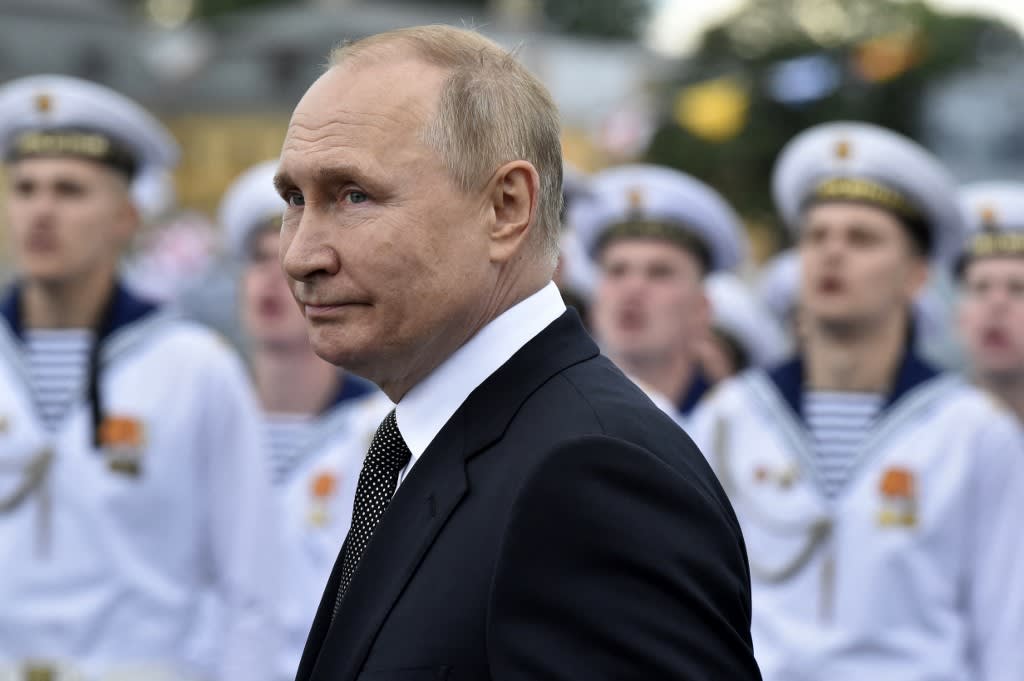 Russia's president Vladimir Putin reviews naval troops as he attends the main naval parade marking the Russian Navy Day, in St. Petersburg on July 31, 2022.
