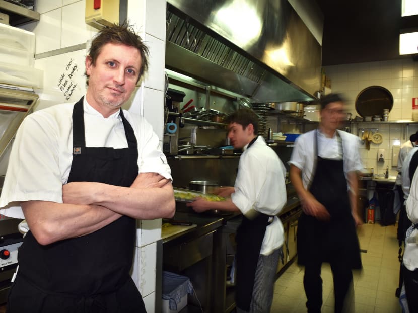 Mr Ben Willis, chef and owner of Aubergine restaurant, left, poses inside the kitchen of his restaurant in Canberra. Photo: Bloomberg