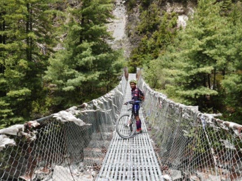 Nur Azhami crosses a suspended bridge on her way to the summit of Annapurna in Nepal. Photo: Malay Mail