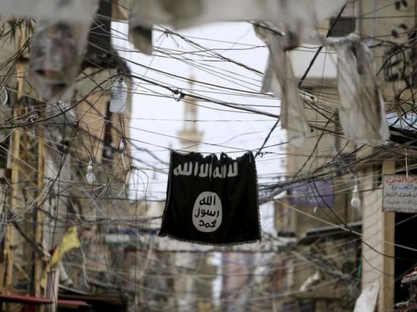 A flag of the Islamic State in Iraq and Syria (Isis) hangs among electrical wires. Ahmed Hussein Abdul Kadir Sheik Uduman had been radicalised and wanted to undertake armed violence in Syria in support of the terrorist group.