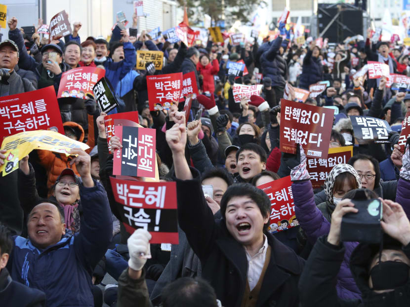 Protesters celebrate after hearing the President Park Geun-hye's impeachment in front of the National Assembly in Seoul, South Korea, Friday, Dec. 9, 2016. Photo: AP