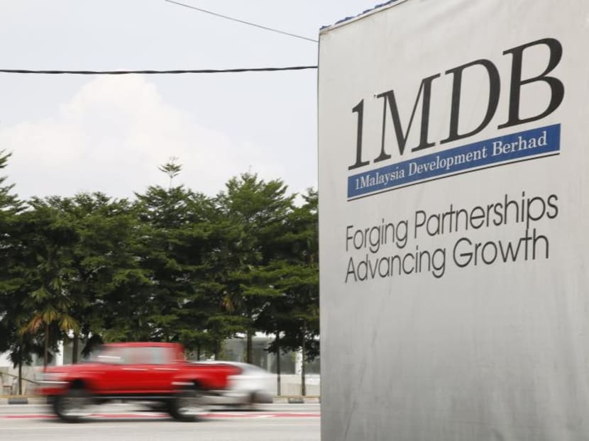 Traffic passes a 1Malaysia Development Berhad (1MDB) billboard at the Tun Razak Exchange development in Kuala Lumpur, Malaysia, on July 6, 2015. Photo: Reuters