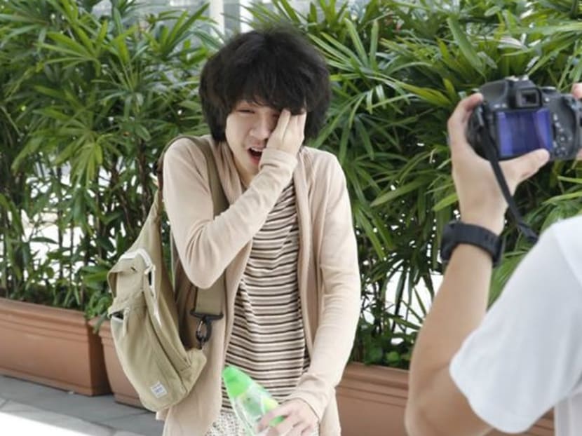As ‪‎Amos Yee‬ was making his way into court today for his pre-trial conference, a stranger came up and slapped him in the face. Photo: Ernest Chua