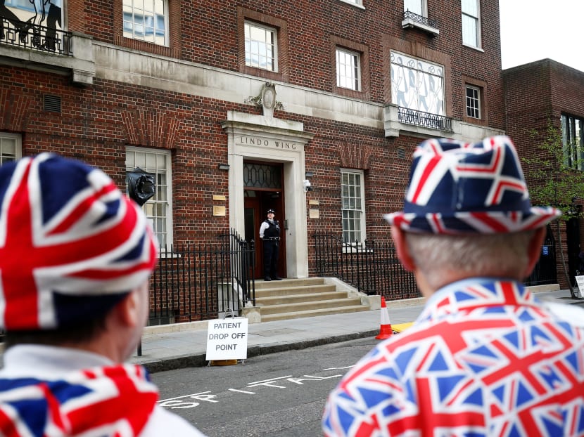 Supporters of the royal family stand outside the Lindo Wing of St Mary's Hospital, after Duchess of Cambridge Kate Middleton was admitted. She went into labour ahead of the birth of her third child, in London.
