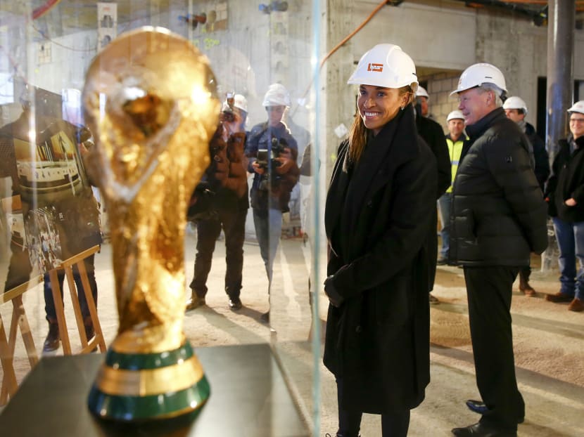 Brazilian soccer player Marta looks at a copy of the FIFA World Cup trophy during her visit to the construction site of the FIFA World Football Museum in Zurich January 13, 2015.  Photo: Reuters