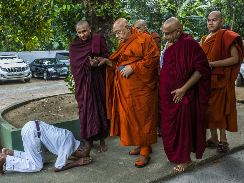 A Sri Lankan Buddhist bows in front of Sitagu Sayadaw, one of Myanmar’s most revered Buddhist leaders, in Delgoda, Sri Lanka. Incited by a politically powerful network of charismatic monks, Buddhists have entered the era of militant tribalism, casting themselves as spiritual warriors who must defend their faith against an outside force. A Sri Lankan Buddhist bows in front of Sitagu Sayadaw, one of Myanmar’s most revered Buddhist leaders, in Delgoda, Sri Lanka. Incited by a politically powerful network of charismatic monks, Buddhists have entered the era of militant tribalism, casting themselves as spiritual warriors who must defend their faith against an outside force.
