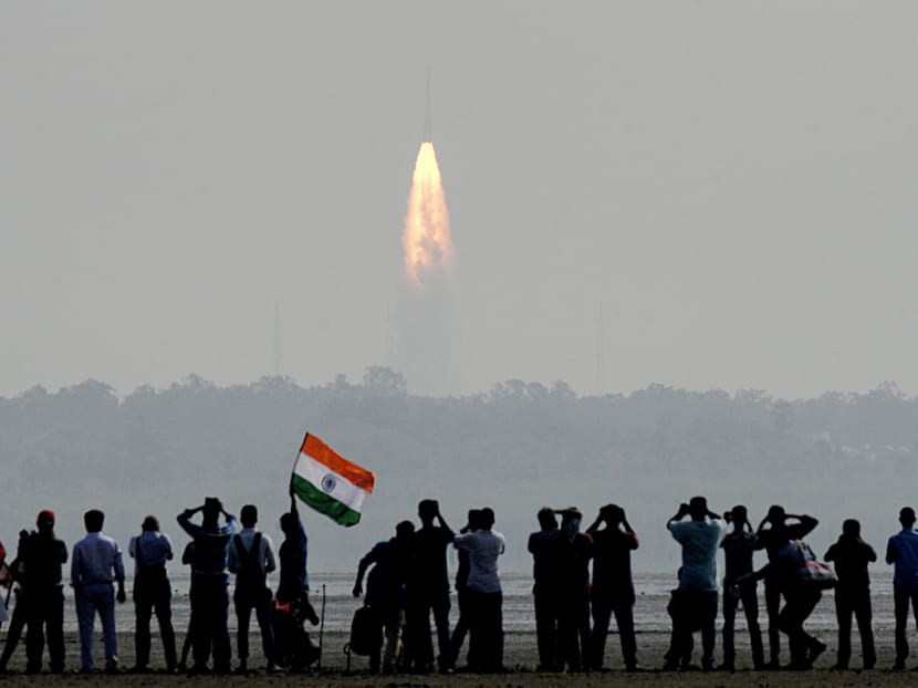 Onlookers watch the launch of the Indian Space Research Organisation (ISRO) Polar Satellite Launch Vehicle (PSLV-C37) at Sriharikota, which carried 104 satellites into space. Photo: AFP
