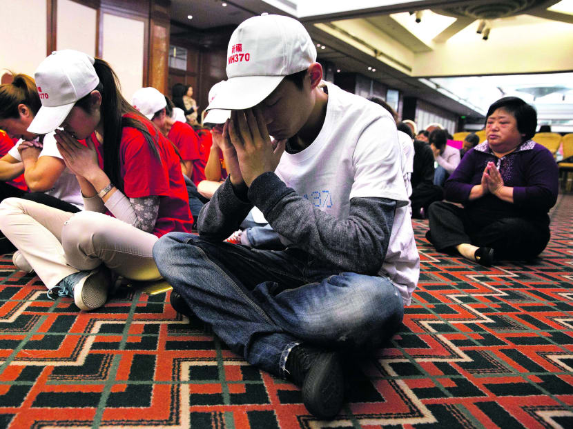 About three dozen relatives held a prayer service yesterday at a hotel ballroom in Beijing where they have been meeting since the plane vanished. Many of those gathered sobbed as gentle music played. PHOTO: AP