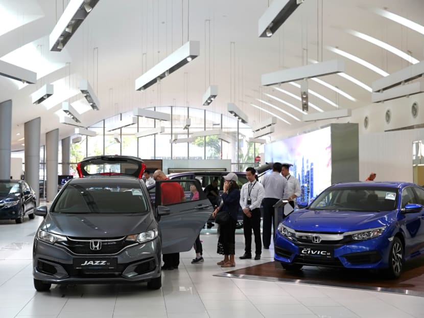 People visiting the Honda car showroom a day after Certificate of Entitlement (COE) premiums for cars fell to their lowest in eight years, July 5, 2018.